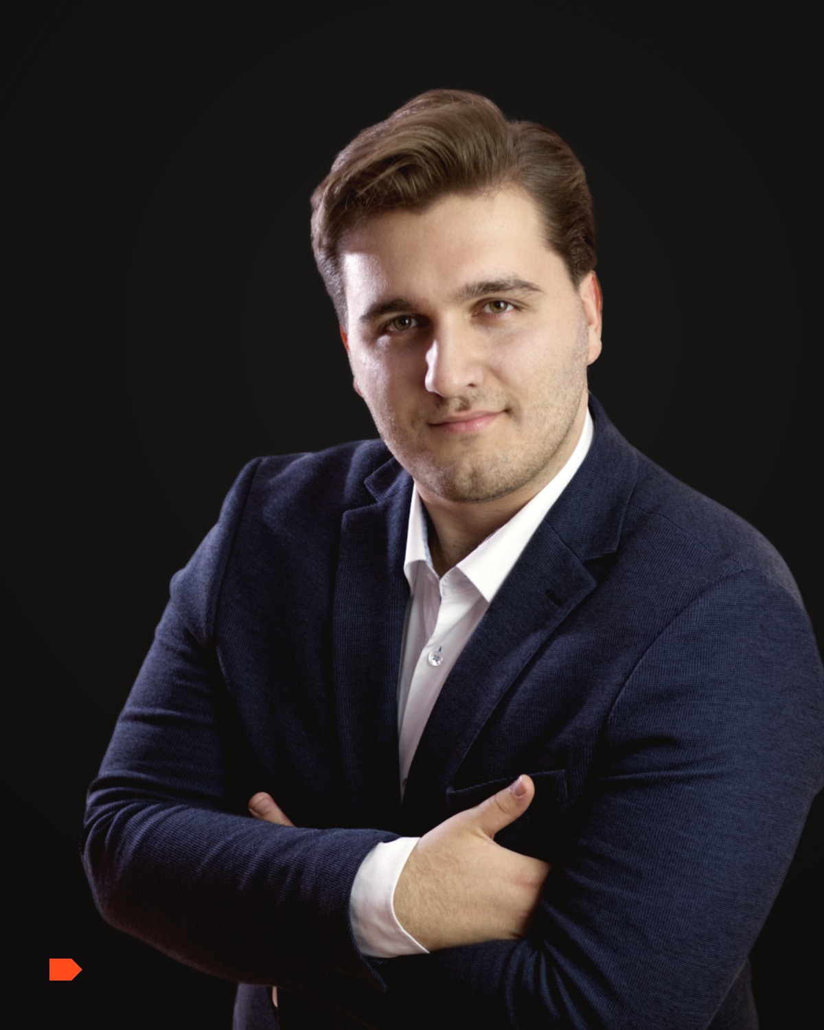 Zivko Gvozdenovic, founder of Hot Iron Studio, arms crossed, in a dark jacket against a dark ground.